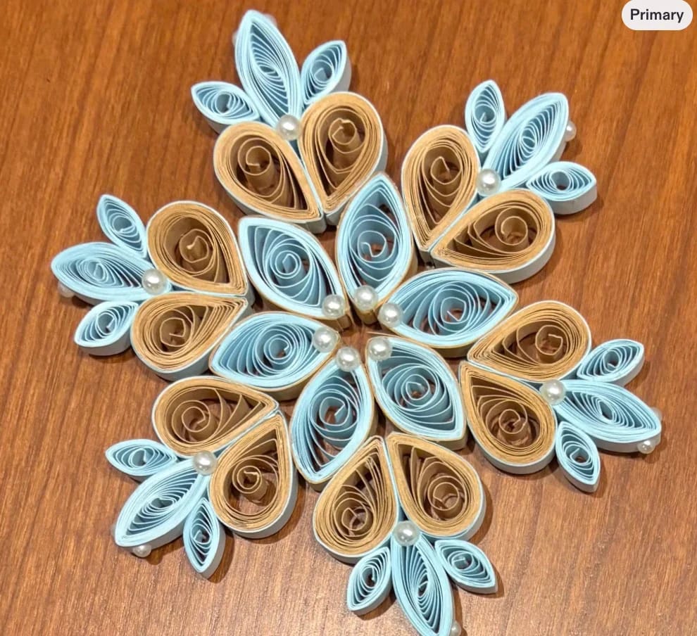 Hand-quilled paper Christmas ornament featuring intricate dimensional paper coils and delicate pearl embellishments.
