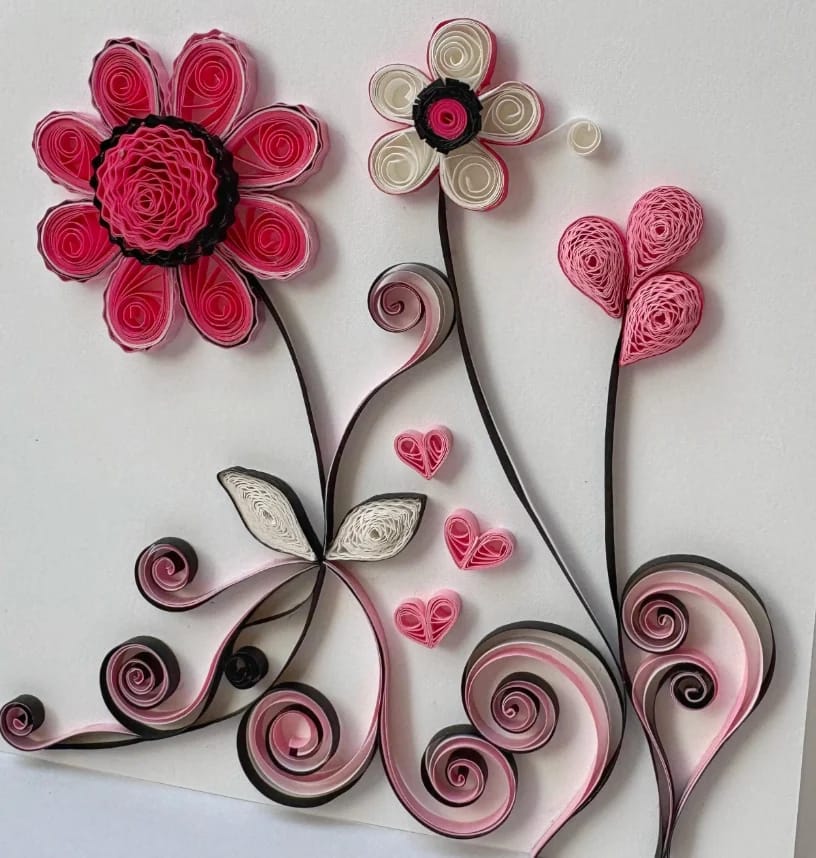 Hand-quilled paper card with intricate coils and delicate embellishments.